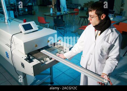 LED street lighting. Technician making an LED street lighting system to be used in Torraca, Italy. Torraca is the first municipality in the world to i Stock Photo