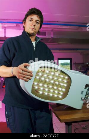 LED street lighting. Technician holding the 'element' from an LED street lighting array to be used in Torraca, Italy. Torraca is the first municipalit Stock Photo