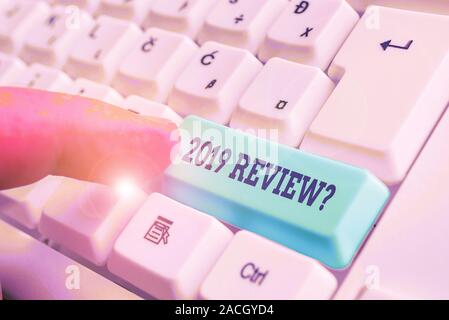 Conceptual hand writing showing 2019 Review Question. Concept meaning remembering past year events main actions or good shows White pc keyboard with n Stock Photo