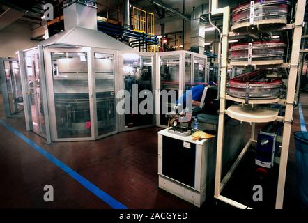 Coffee factory. Factory worker in the roasting and packing room of a coffee processing factory. Photographed at the Lavazza factory, Turin, Italy. Stock Photo