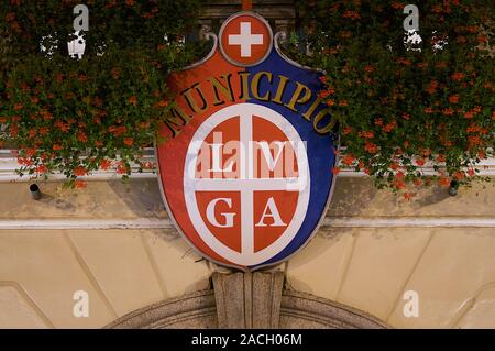 Lugano, Ticino, Switzerland - 17th August 2019 : Picture of the coat of arms of the city of Lugano hanging at the entrance of the city hall in Piazza