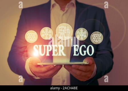 Writing note showing Super Ego. Business concept for The I or self of any demonstrating that is empowering his whole soul Male wear formal work suit p Stock Photo