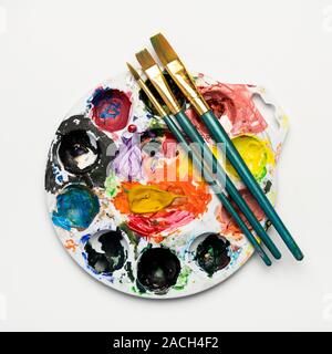 Color mixing plate and paintbrushes Stock Photo