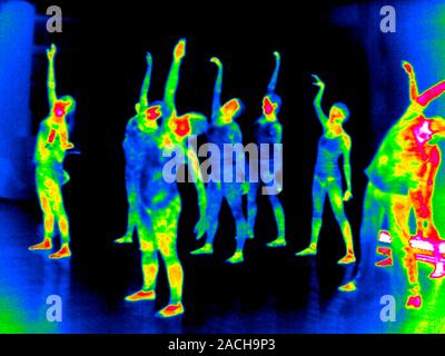 Aerobic exercises. Thermogram of a group of people doing aerobic exercises at a gym. Thermography records surface temperatures by detecting the long-w Stock Photo