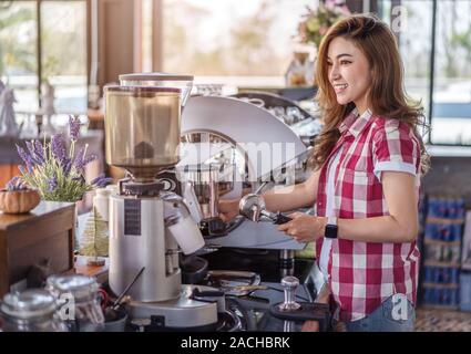 woman preparing coffee with machine in a cafe Stock Photo