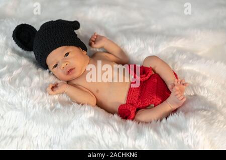 newborn baby in mouse costume on a fur bed Stock Photo