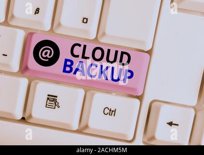 Word writing text Cloud Backup. Business photo showcasing enable customers to remotely access the provider s is services White pc keyboard with empty Stock Photo