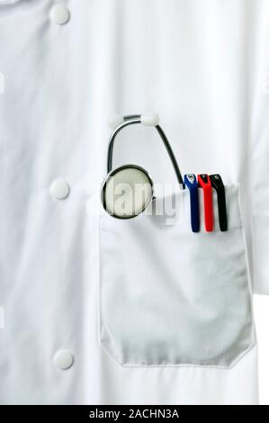 Doctor's pocket. Stethoscope and pens in the pocket of a white coat. Stock Photo