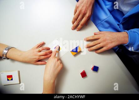 Cognition test for coma patient. The recovering patient (upper right) is undergoing a neuropsychological test called the Wisconsin Card Sorting Test ( Stock Photo