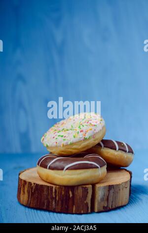 donuts lying on the table. blue background. Stock Photo