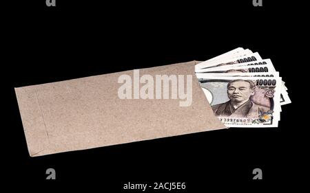 Japan money inside paper envelope on a black background Stock Photo