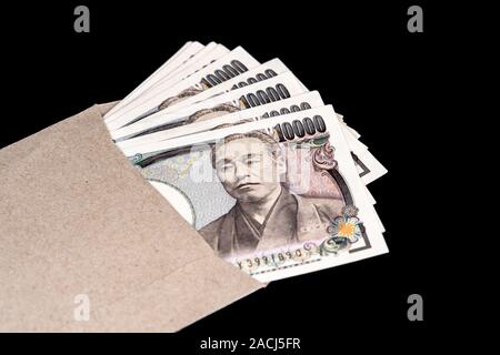 Japan money inside paper envelope on a black background Stock Photo