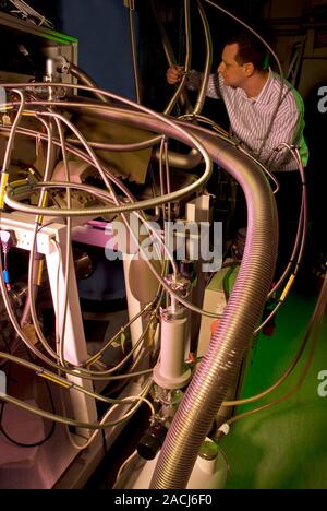 Counterfeit drug detection. Researcher working on an apparatus (cryogenic cooling system seen here) designed to detect counterfeit pharmaceutical drug Stock Photo
