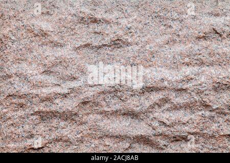 Background and texture of a granite wavy wall in a rock of a mountain for decor and interior decoration. Design and patterns. Stock Photo