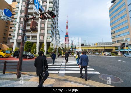 TOKYO, JAPAN - March 25, 2019: Unidendified people walk across the street in Tokyo city, Japan Stock Photo