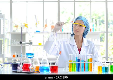 The woman scientist in laboratory doing experiments Stock Photo