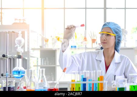 The woman scientist in laboratory doing experiments Stock Photo