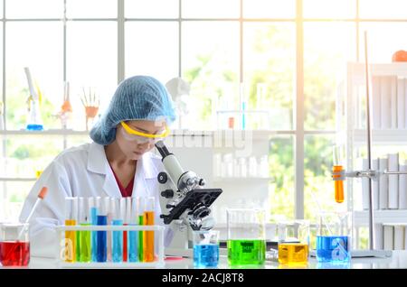 The woman scientist doing experiment using microscope in laboratory. Photo concept of Medical healthcare technology and pharmaceutical research and de Stock Photo