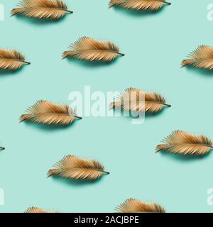 Seamless creative texture. Golden painted tropical Lip-shaped leaf on pastel background. Stock Photo