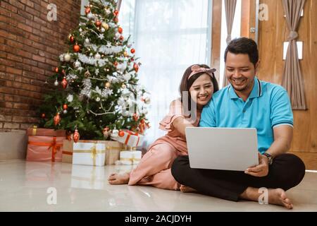 asian couple using laptop on christmas day Stock Photo