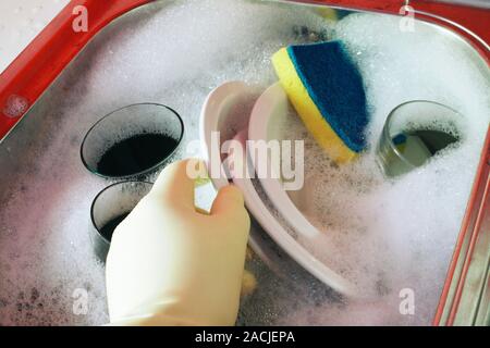 Washing up. Close-up of someone washing dishes in a sink. Stock Photo
