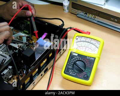 Using a multimeter. Multimeters are electronic measuring instruments which contain both an ammeter and voltmeter, enabling them to measure current, vo Stock Photo