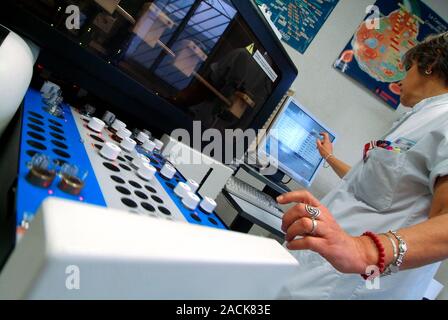 Haematology lab. Technician working with blood samples in a haematology laboratory. Photographed in Antibes, France. Stock Photo