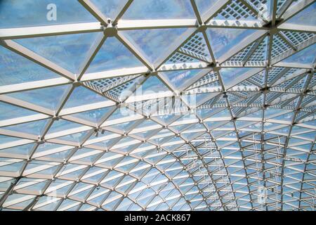Abstract high-tech architecture background photo, internal structure of glass roof arch with lockable windows sections. Transparent glass roof of a mo Stock Photo