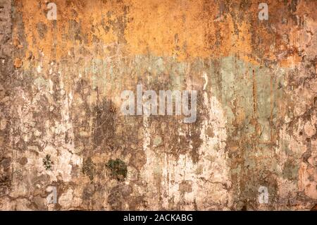 Dirty wall with broken cement plaster. Vintage surface texture. Background for loft style interior. Rusty stains on old concrete wall texture, abstrac Stock Photo