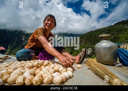 A vendor is selling eggs at the weekly market in town Stock Photo
