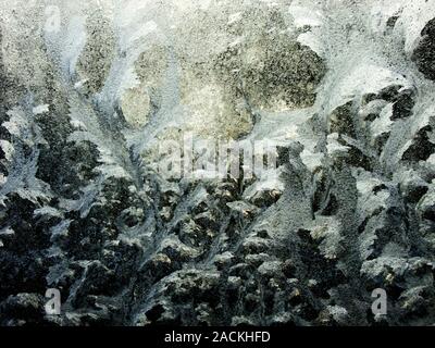 Frost and ice patterns on a window. Photographed in winter. Stock Photo
