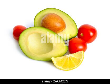 Avocado with tomatoes and lemon. Ingredients for Guacamole. Isolated Stock Photo