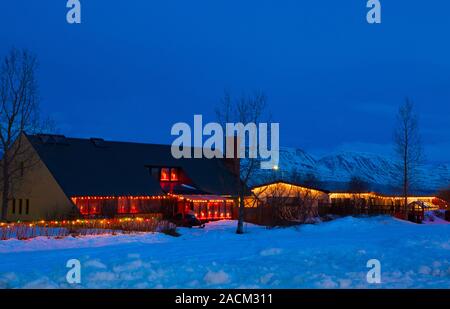 Typical Icelandic houses with Christmas lights at dusk (near Akureyri), Northern Iceland. Stock Photo