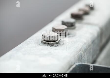Abstract industrial background with gray bolts connection, close-up photo with selective soft focus Stock Photo