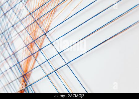 Abstract background photo with colorful treads intersections over white wall, geometric pattern Stock Photo