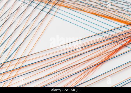 Abstract background photo with colorful treads intersections over blank white wall, geometric pattern Stock Photo