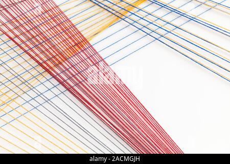Abstract background photo with colorful treads over white wall, geometric pattern Stock Photo