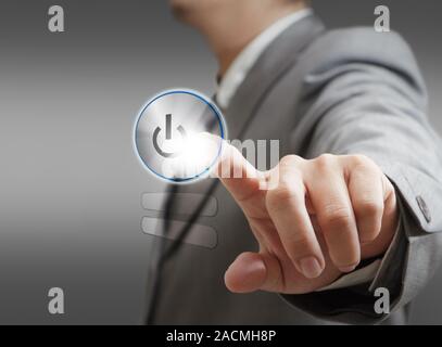 hand pushing a button on a touch screen interface Stock Photo