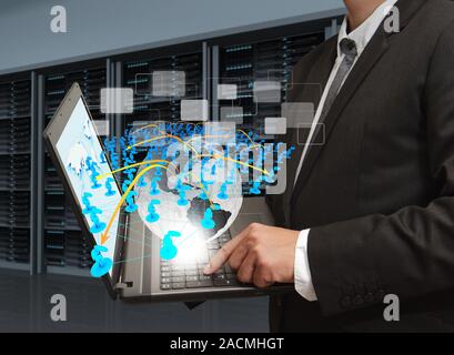 Business man holds laptop computer and social network in server room Stock Photo
