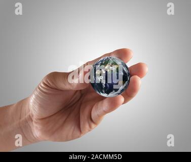 holding a glowing earth globe Stock Photo