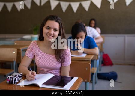 Teenagers in school classroom Stock Photo