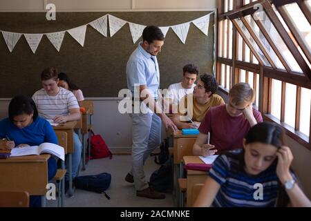 Teenagers in school classroom Stock Photo