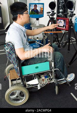 Robotic wheelchair interface research. Researcher testing a computer interface to be used by wheelchair users to control their wheelchair using facial Stock Photo