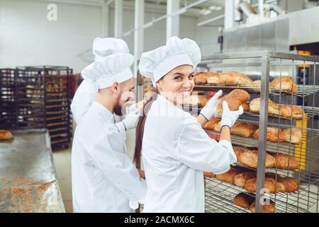 Smiling colleagues working in bakery manufacture Stock Photo