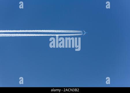 Aircraft with vapour trails Stock Photo