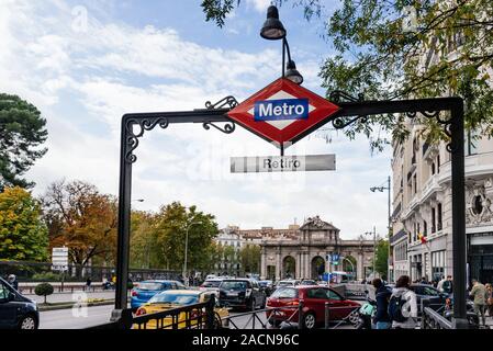 Madrid, Spain - November 2, 2019: Metro sign in Retiro Subway Station in Alcala Street against Puerta de Alcala with busy car traffic in the street Stock Photo