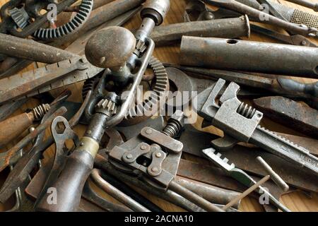 Rusty metal tools. Close-up of a collection of old metal tools that have turned rusty. Rust (orange) is hydrated iron oxide. It forms as iron reacts w Stock Photo