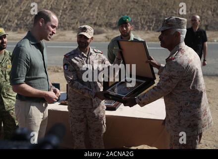 The Duke of Cambridge is presented with a gift at the Sheikh Salim Al-Ali National Guard Camp as he joins UK and Kuwaiti troops as they take part in Exercise Desert Warrior, as part of his tour of Kuwait and Oman. Stock Photo
