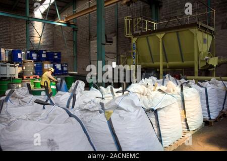 Heavy metals recycling factory. Worker at a factory that specialises in recycling products that contain heavy metals. The term 'heavy metal' generally Stock Photo