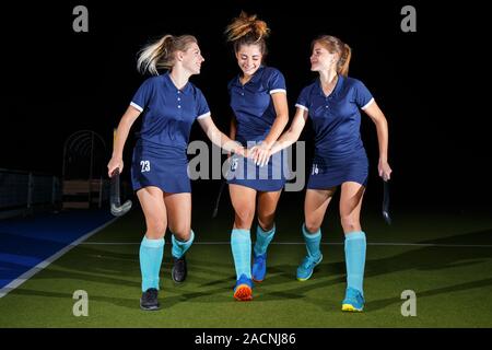 Group of female field hockey players celebrate the victory Stock Photo